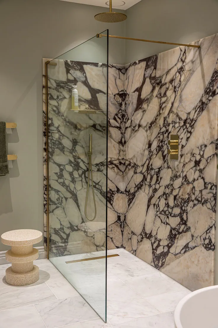 Trending bathroom wall paneling with Calacatta Viola marble effect, matte finish.